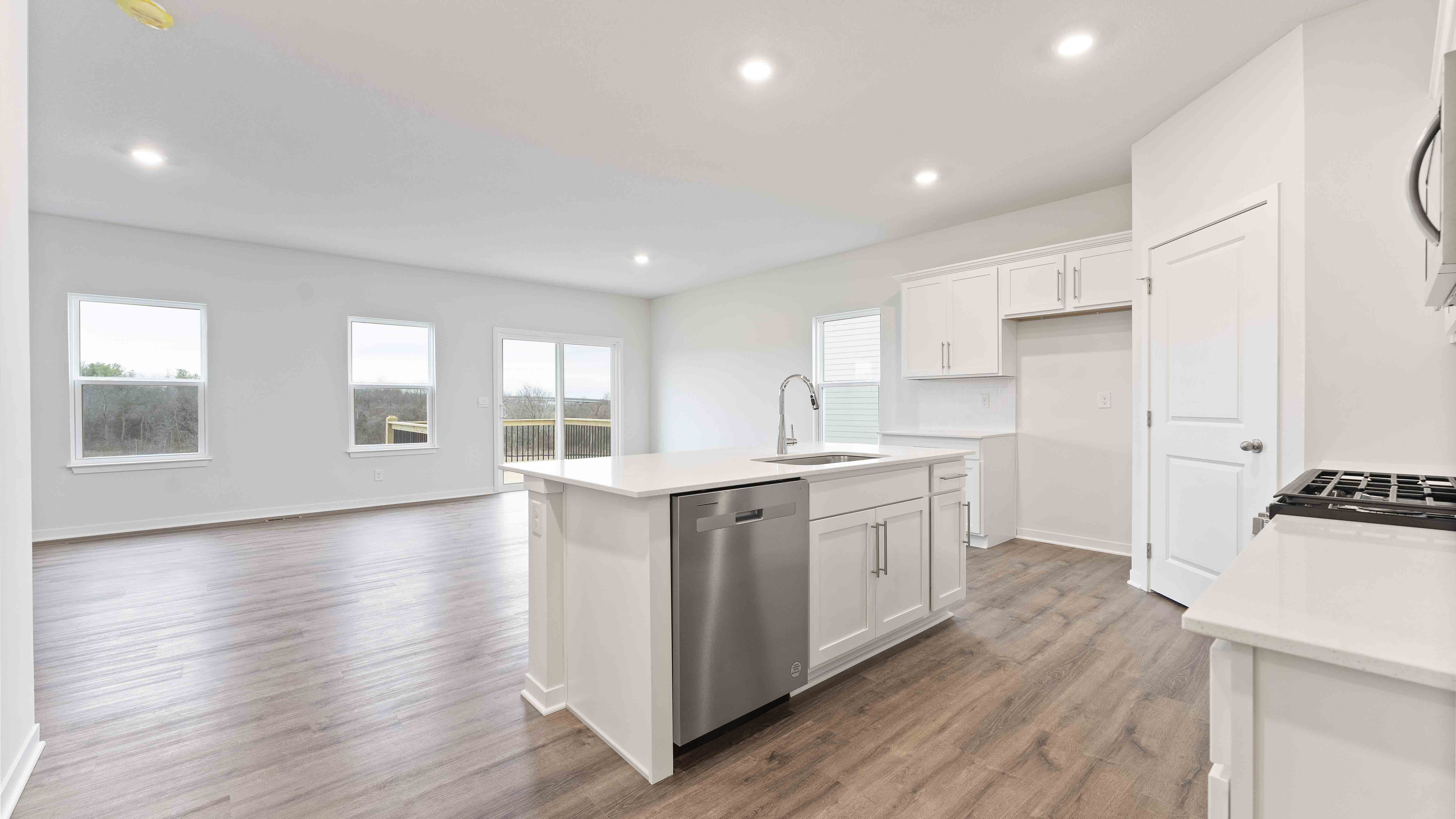 Kitchen with white cabinets and countertops and stainless steel appliances
