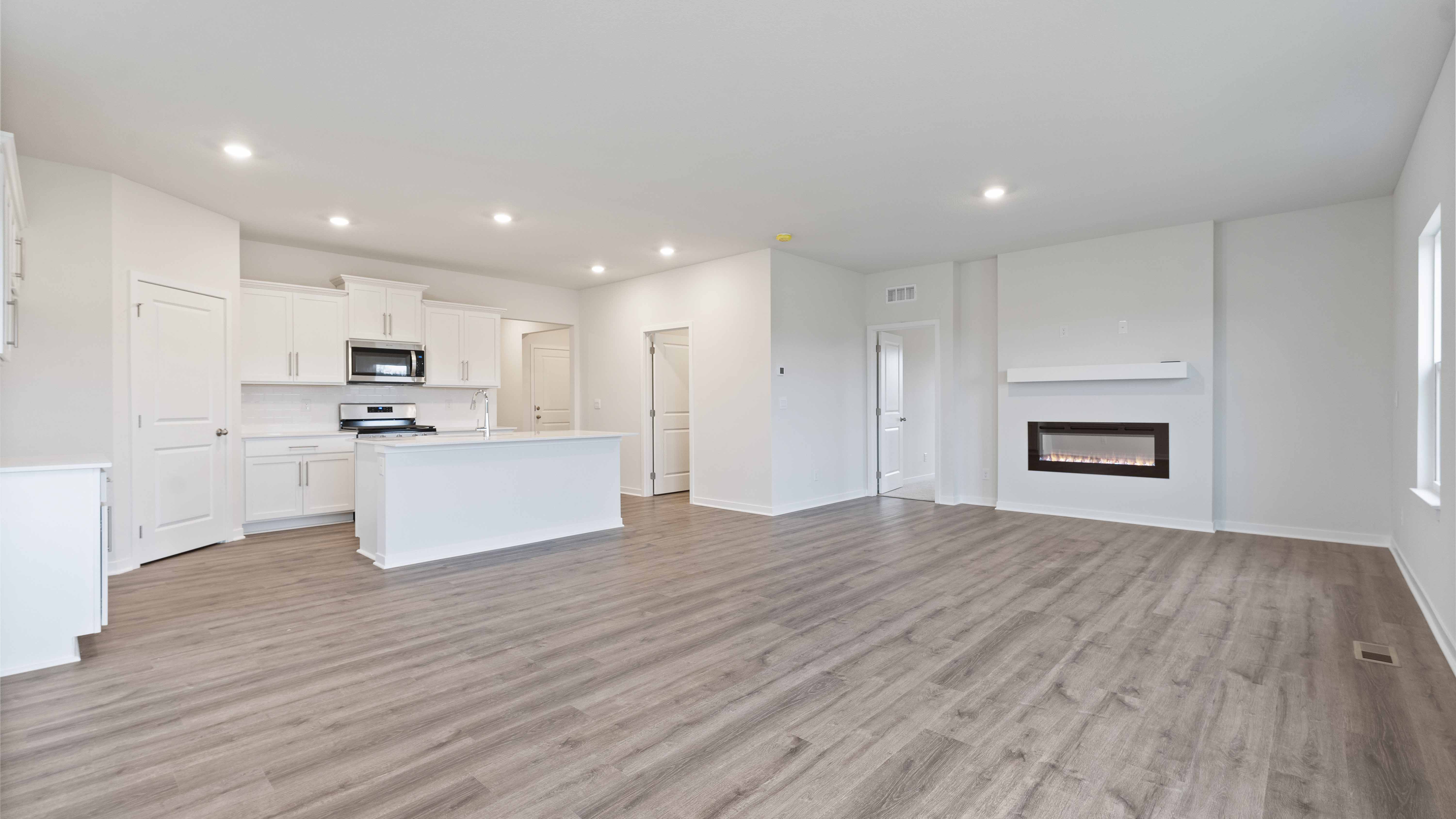 Open concept living area with large windows and fireplace