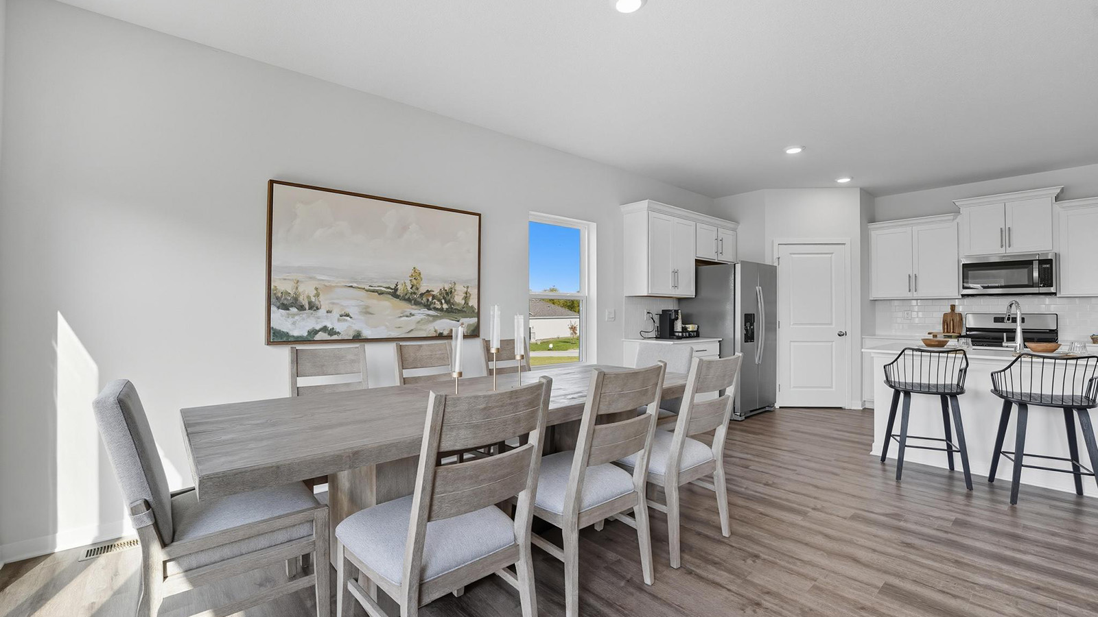 Dining area beside kitchen and living room with sliding glass back door and small window