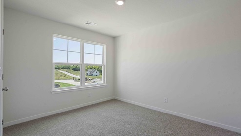 Carpeted bedroom with large window