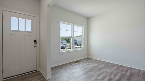 Welcoming foyer with view of dining room area with large window