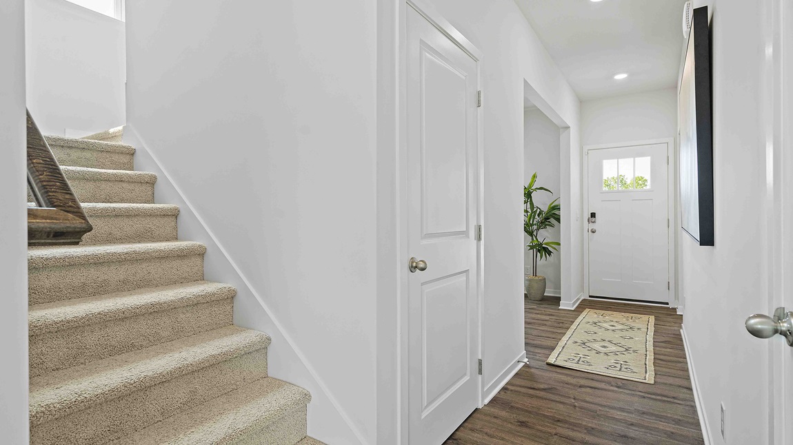 Welcoming foyer with view of dining room area with large window