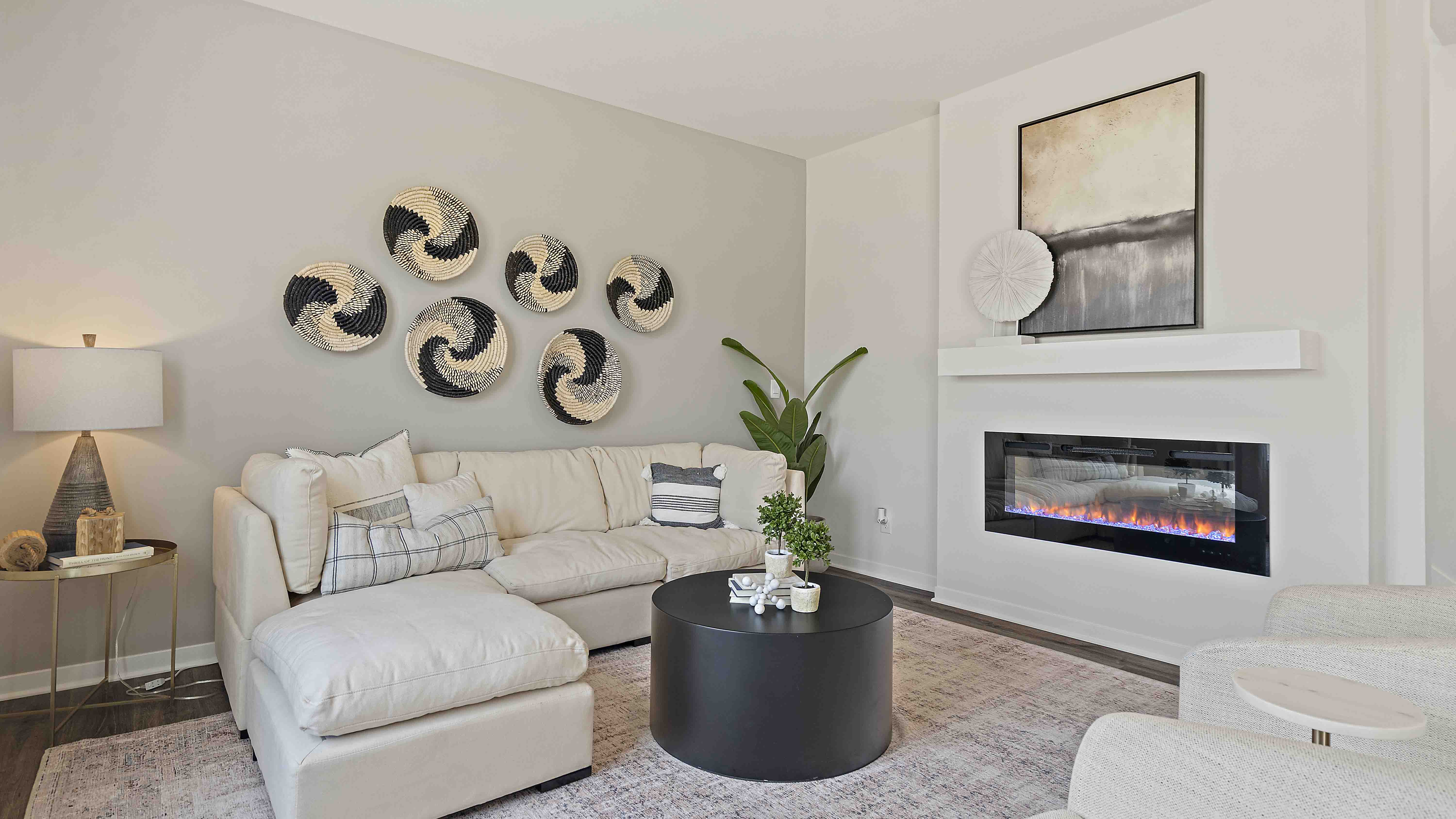 Living room beside kitchen, with electric fireplace and large window