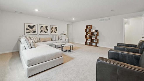 Carpeted loft with large windows