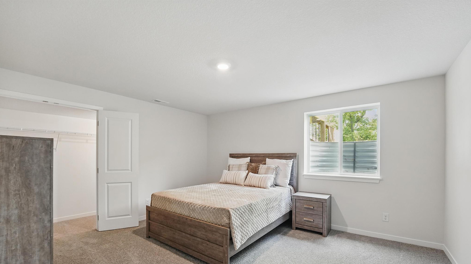 Carpeted bedroom with large windows