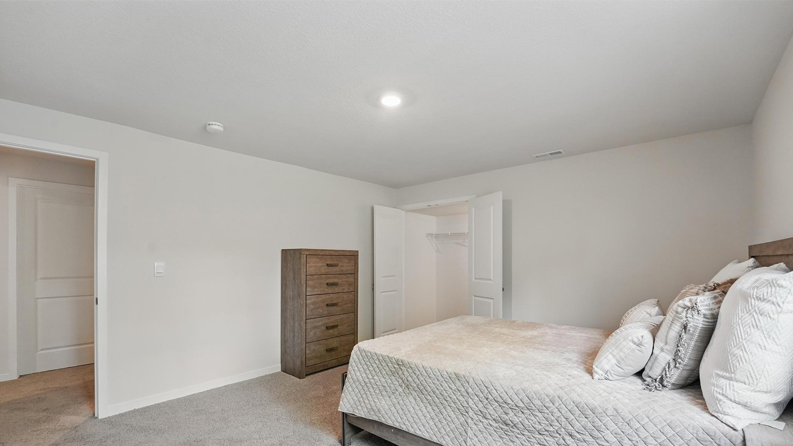 Carpeted bedroom with large windows