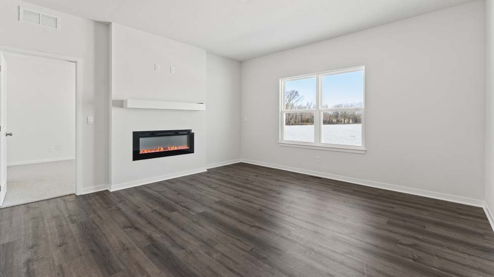 Living area with large windows and fireplace
