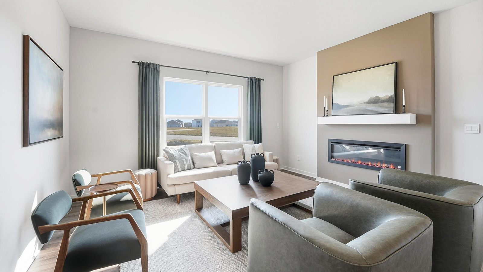 Living room beside kitchen, with electric fireplace and large window