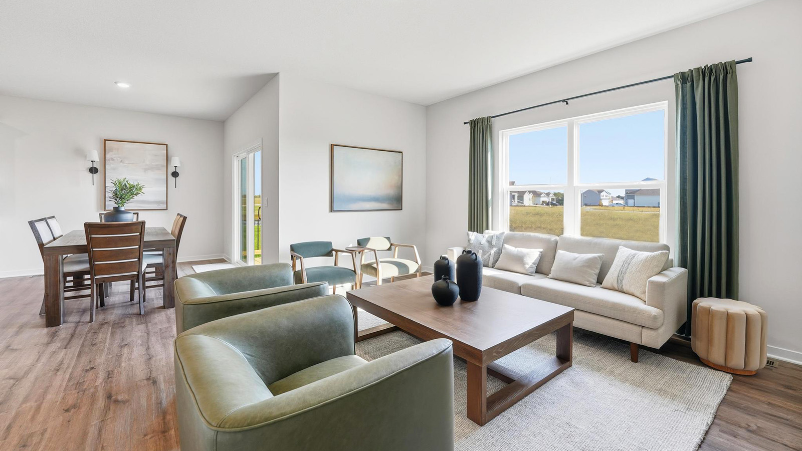 Living room beside kitchen, with electric fireplace and large window