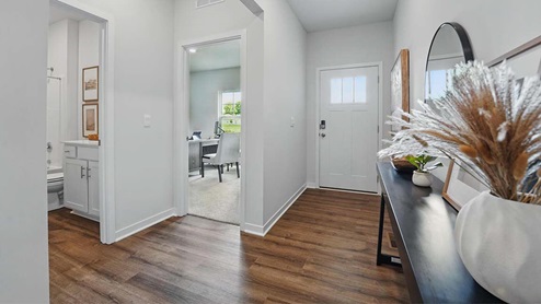 front entry way of home featuring brown flooring and white walls