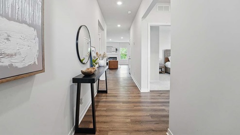 front entry way of home featuring brown flooring and white walls