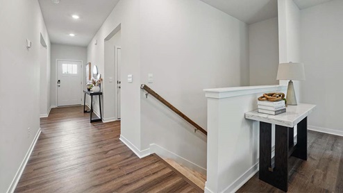 front entry way of home featuring brown flooring and white walls