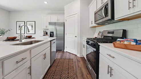 kitchen with white cabinetry, large island, and stainless steel appliances