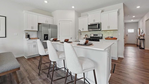 kitchen with white cabinetry, large island, and stainless steel appliances