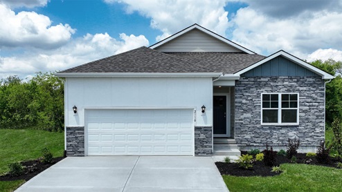 Front exterior of a home with a two car garage, blue and white siding and stone accents