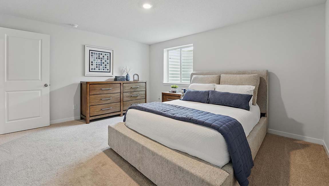 Carpeted bedroom with large windows