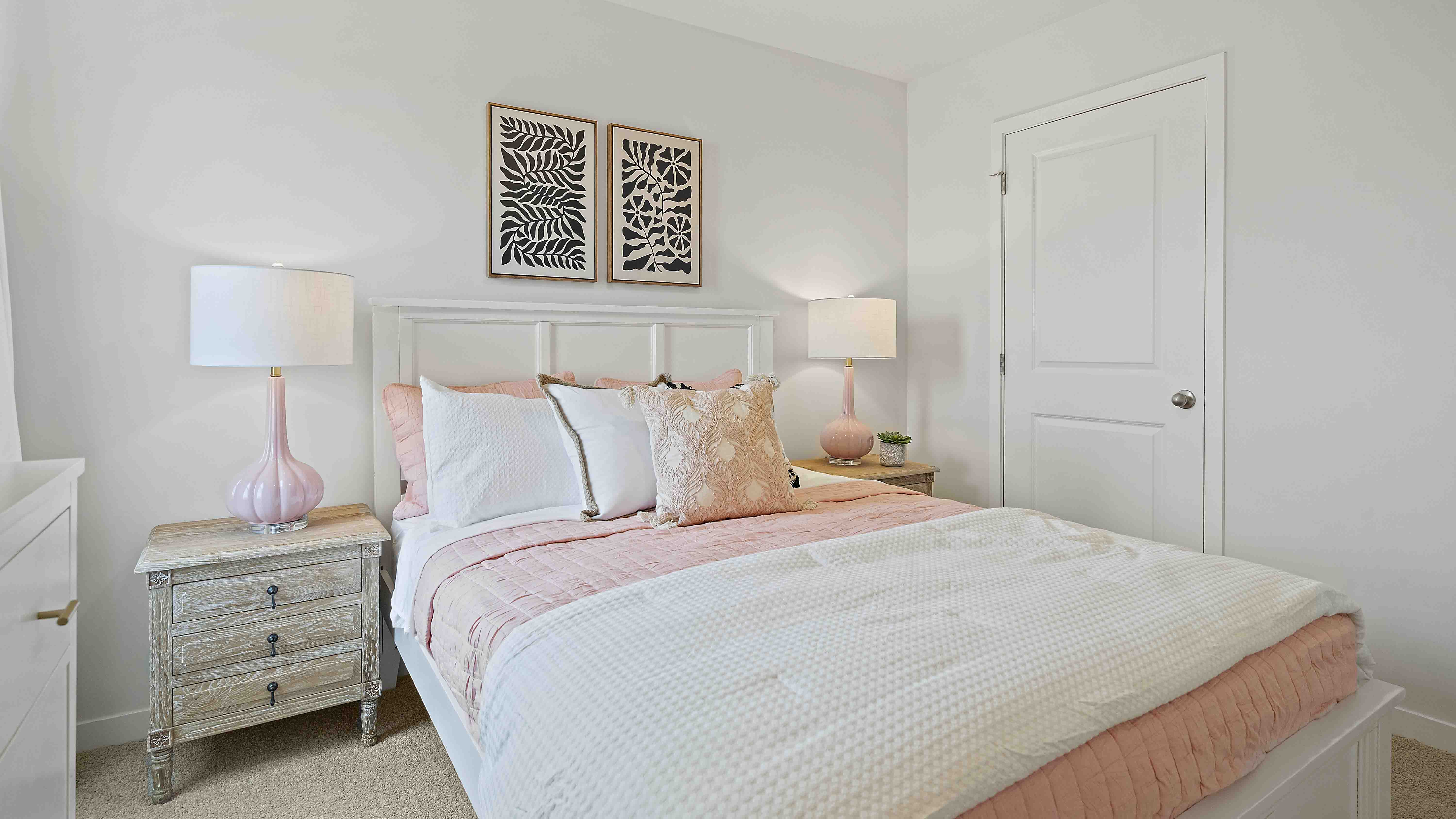 Carpeted bedroom with large window.