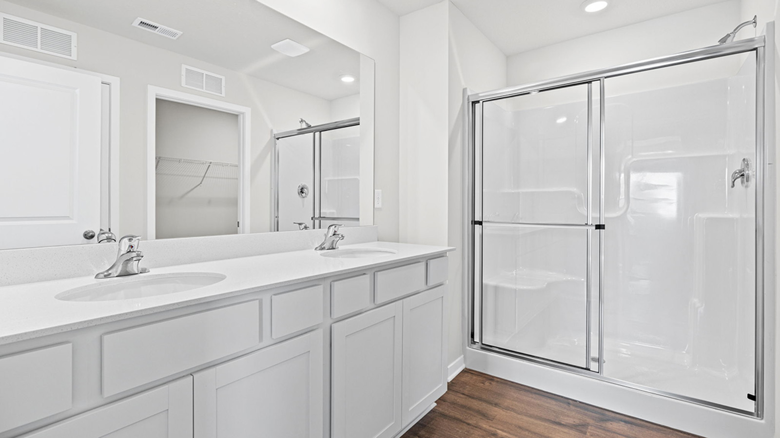 Primary bathroom with standing glass Door shower.