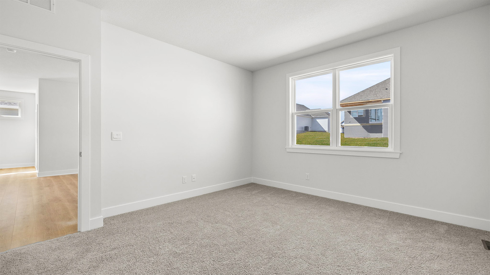 Primary bedroom with carpet, and two large windows