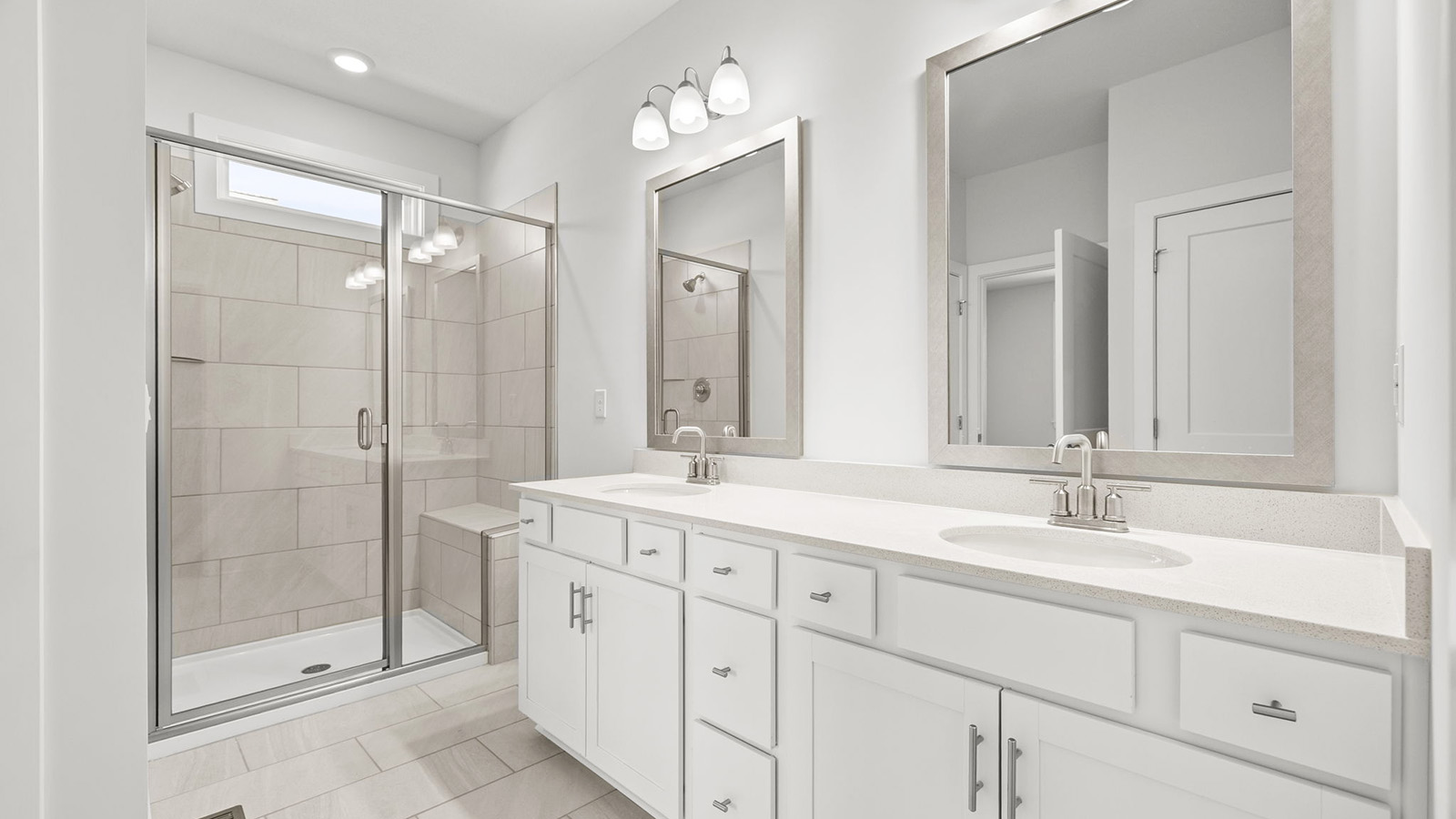 Bathroom with double vanity and shower with glass door