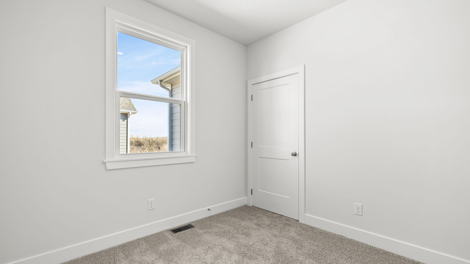 Carpeted bedroom with large window