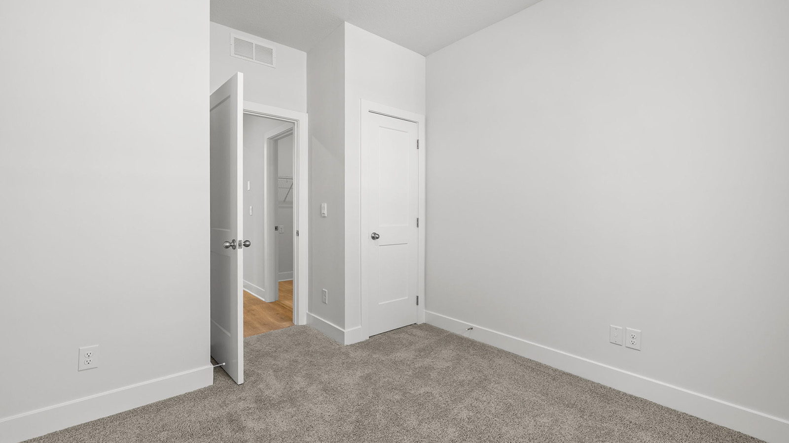 Carpeted bedroom with large window