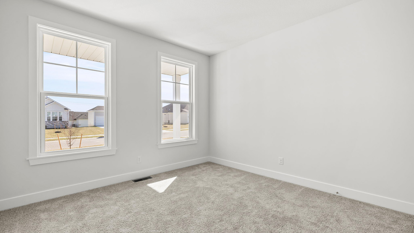 Carpeted bedroom with large window