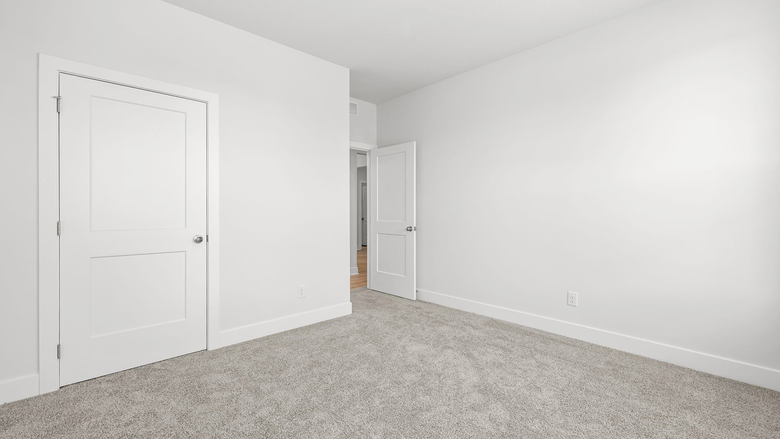 Carpeted bedroom with large window