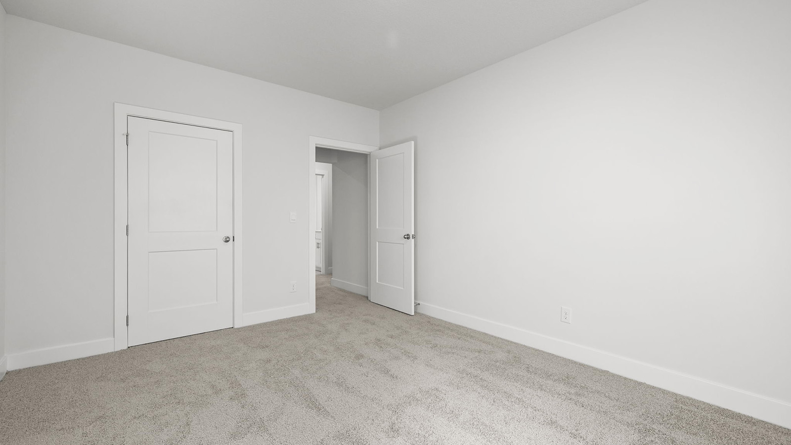 Carpeted bedroom with large window