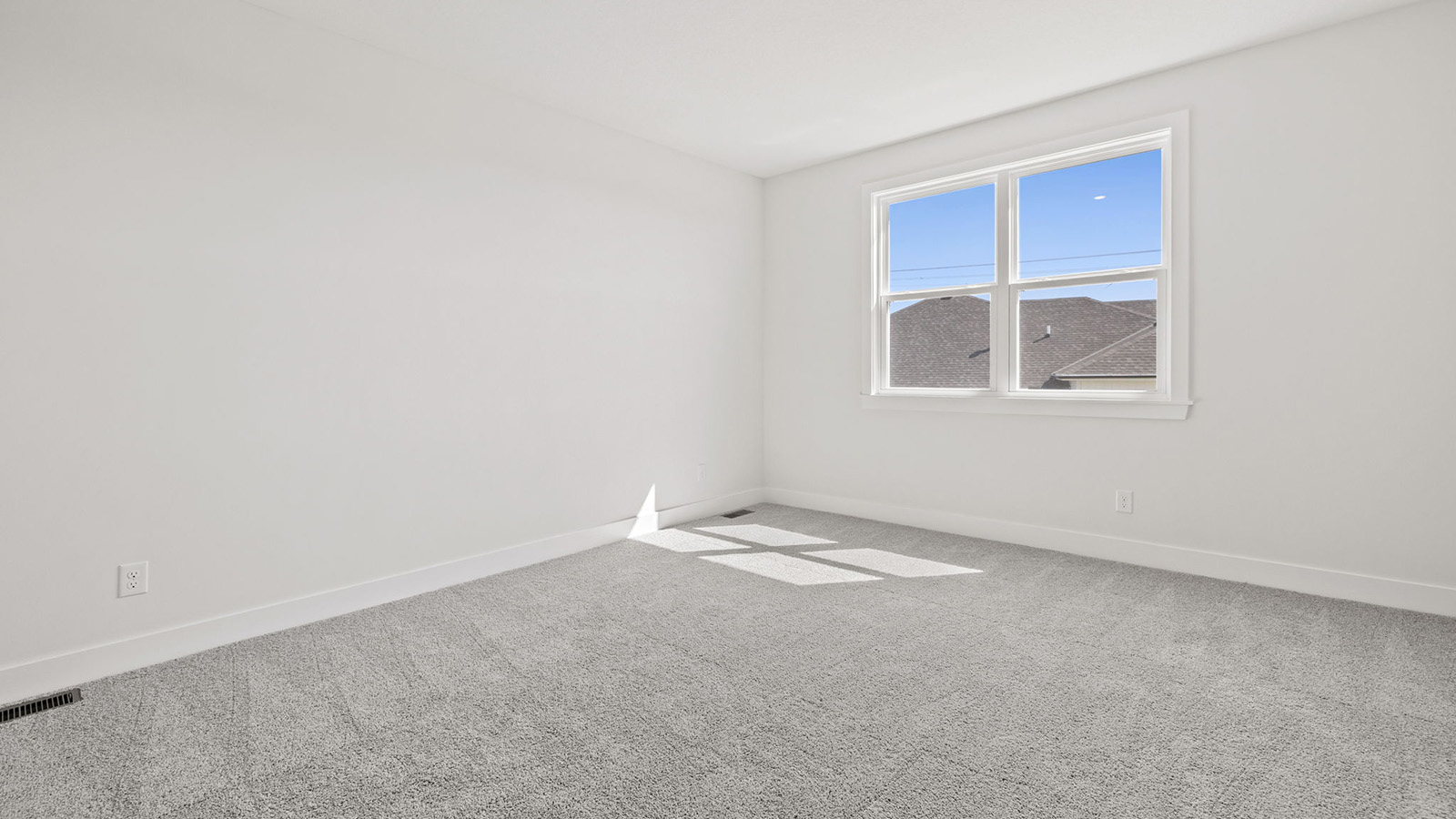 Primary bedroom with carpet, and two large windows