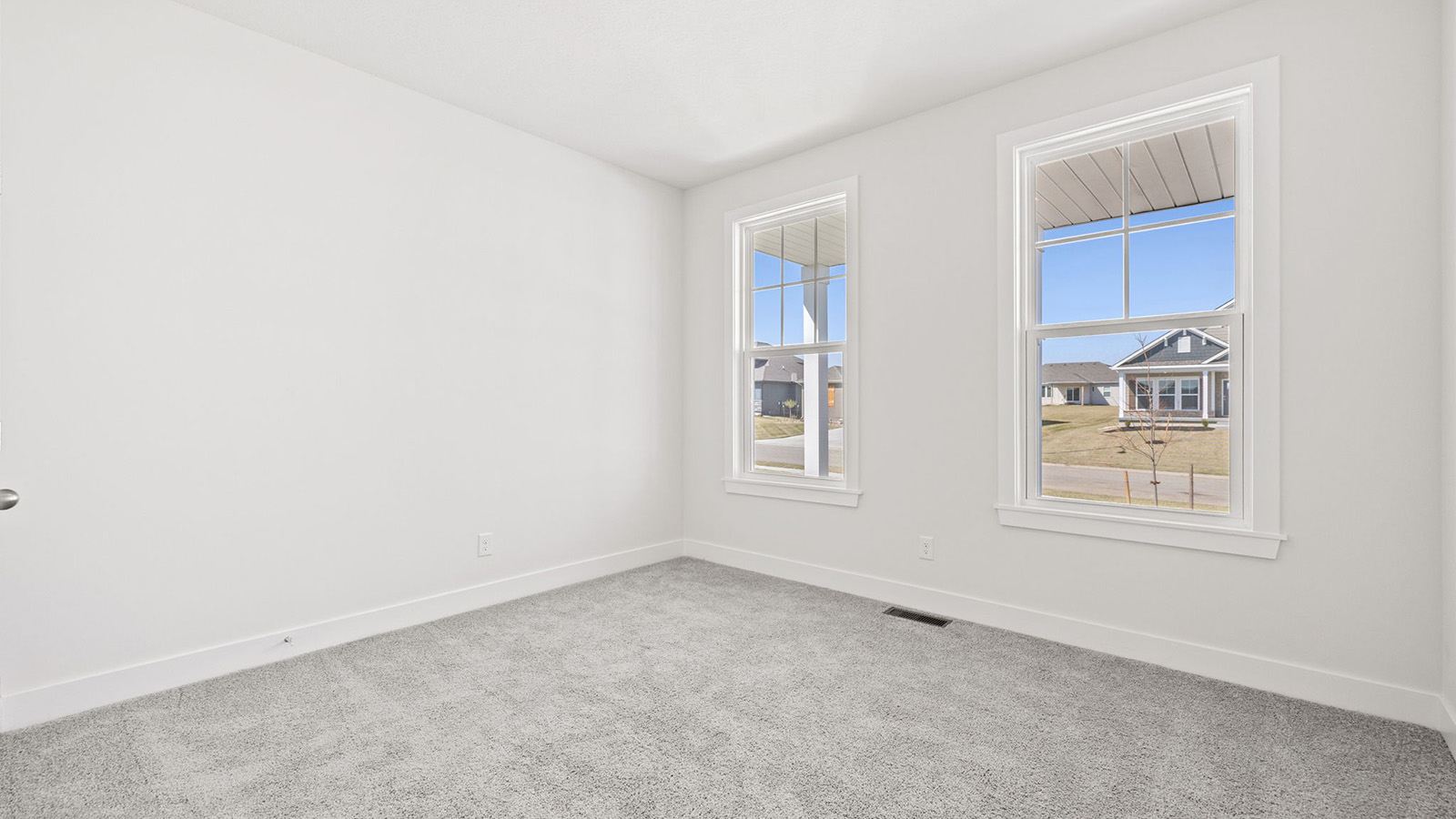 Carpeted bedroom with large windows