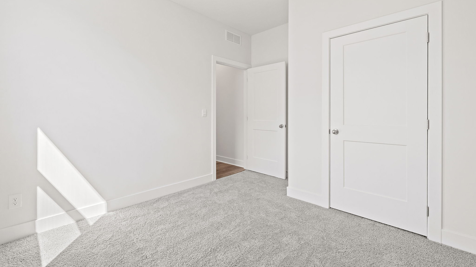 Carpeted bedroom with large window