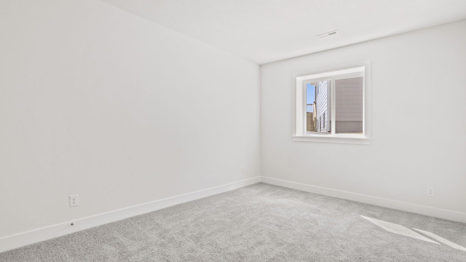 Carpeted bedroom with large window