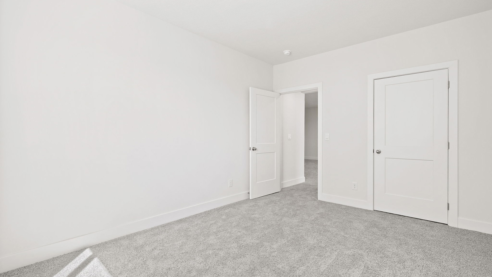 Carpeted bedroom with large window