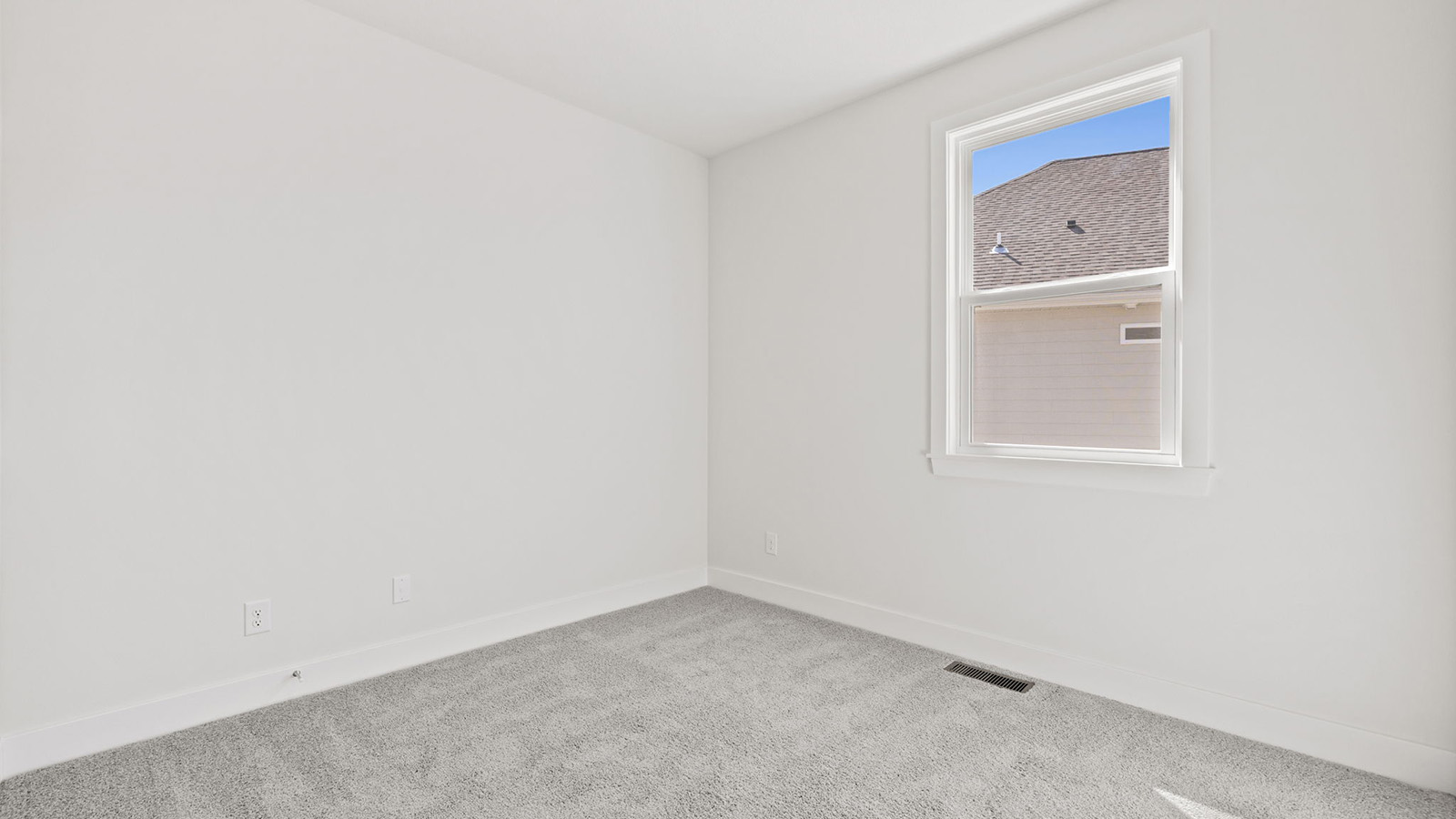 Carpeted bedroom with large window
