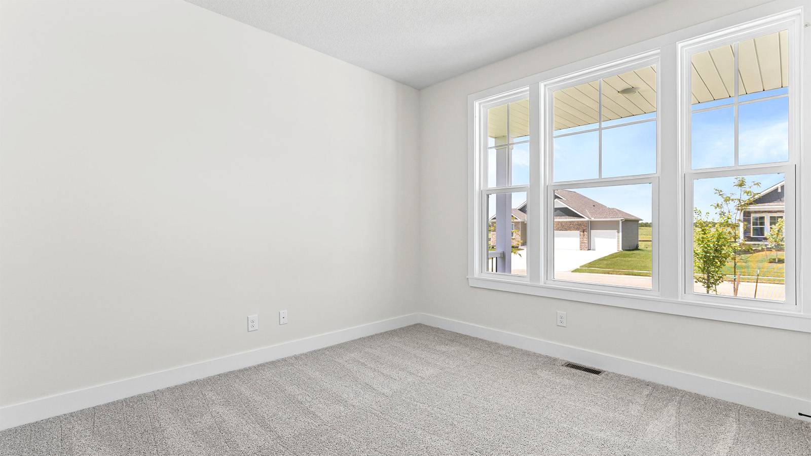Carpeted bedroom with large window