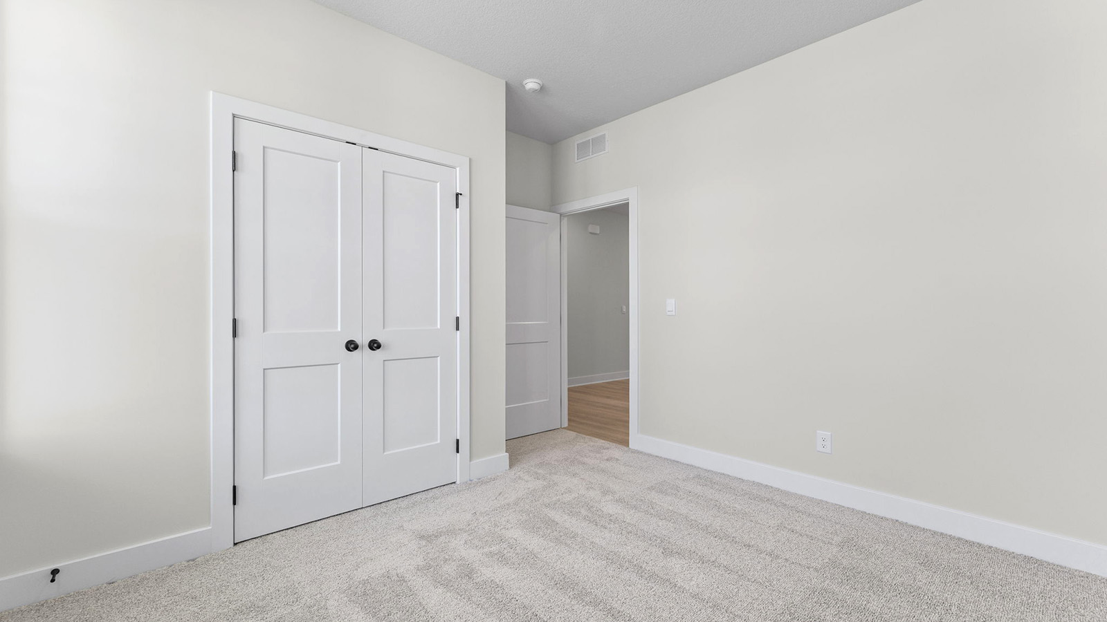 Carpeted bedroom with large window