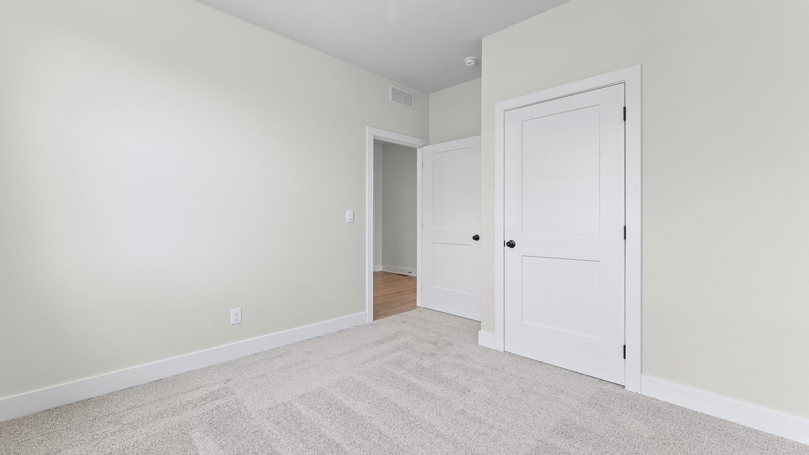Carpeted bedroom with large window