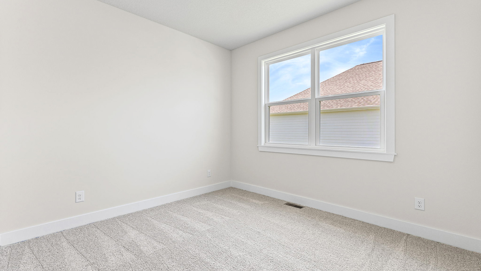 Primary bedroom with carpet, and two large windows