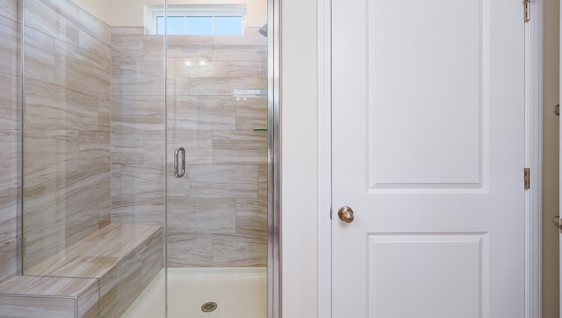 Primary bathroom with double sinks, and white cabinets