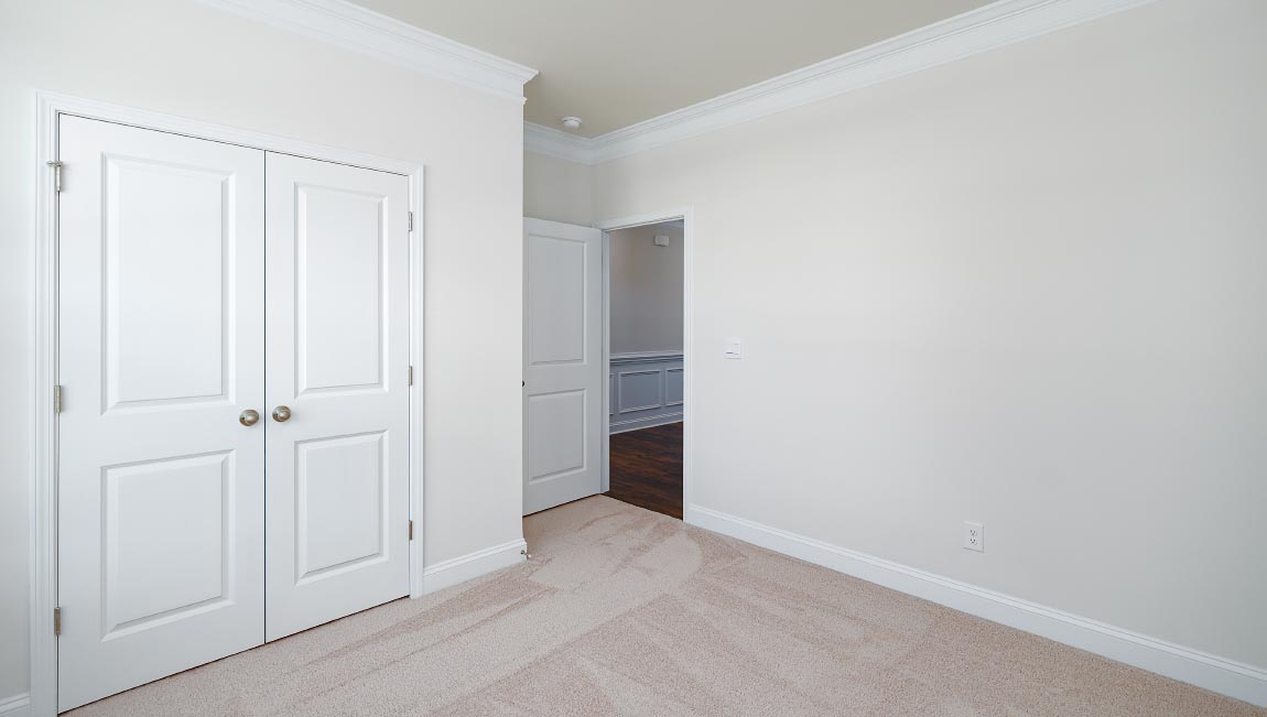 Carpeted bedroom with large window