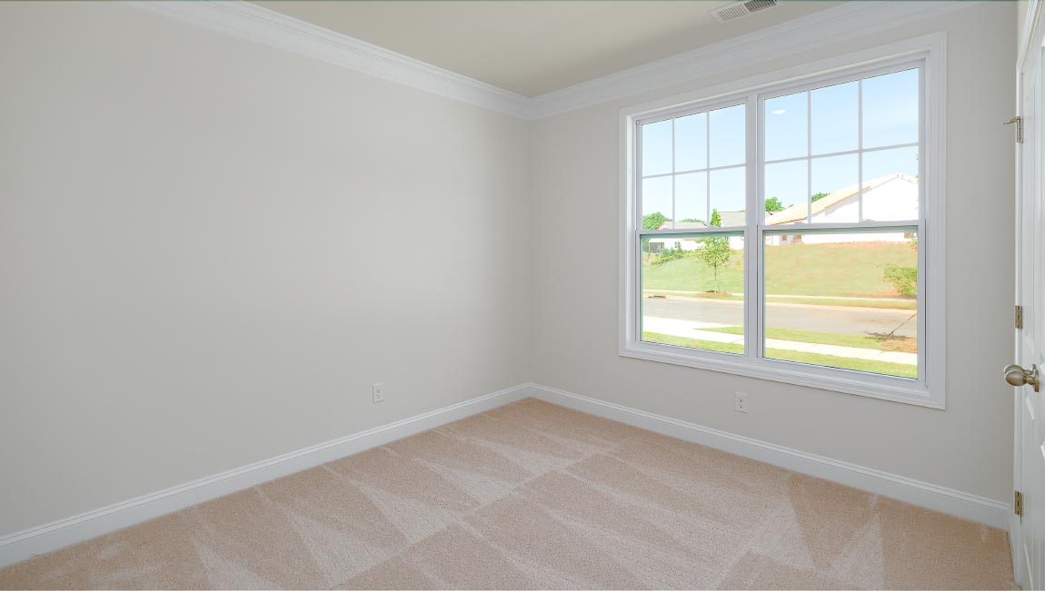 Carpeted bedroom with large window