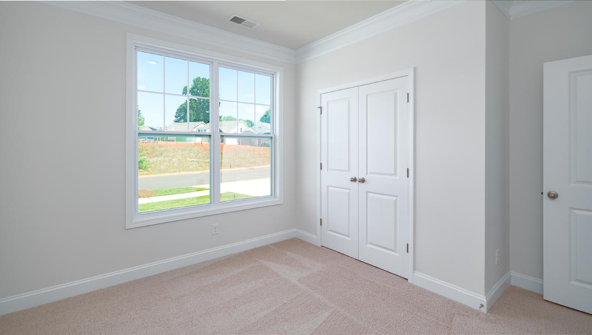 Carpeted bedroom with large window