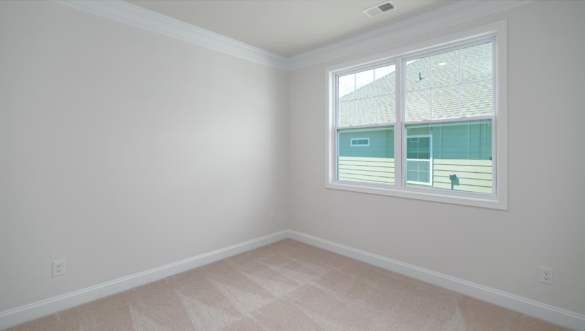 Carpeted bedroom with large window