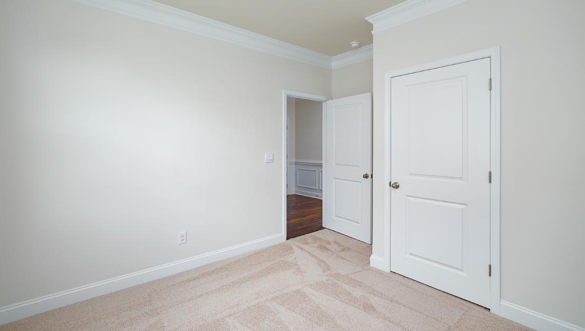 Carpeted bedroom with large window