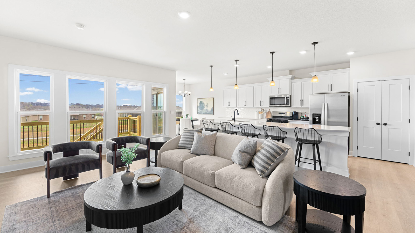 Living room beside kitchen, with electric fireplace and large window
