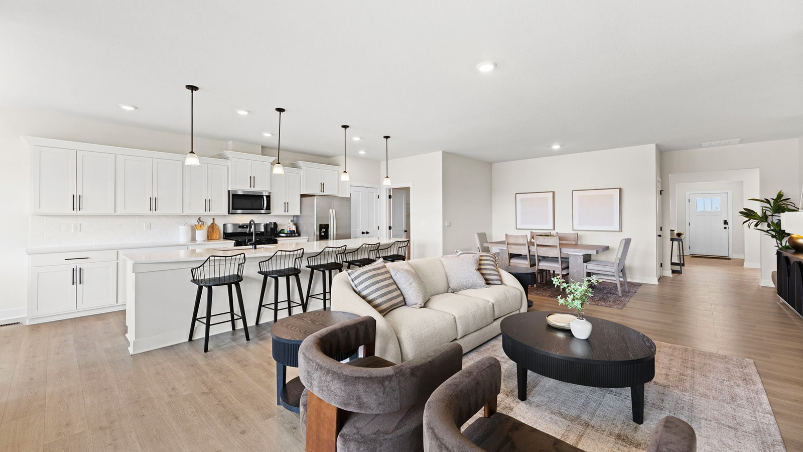 Living room beside kitchen, with electric fireplace and large window