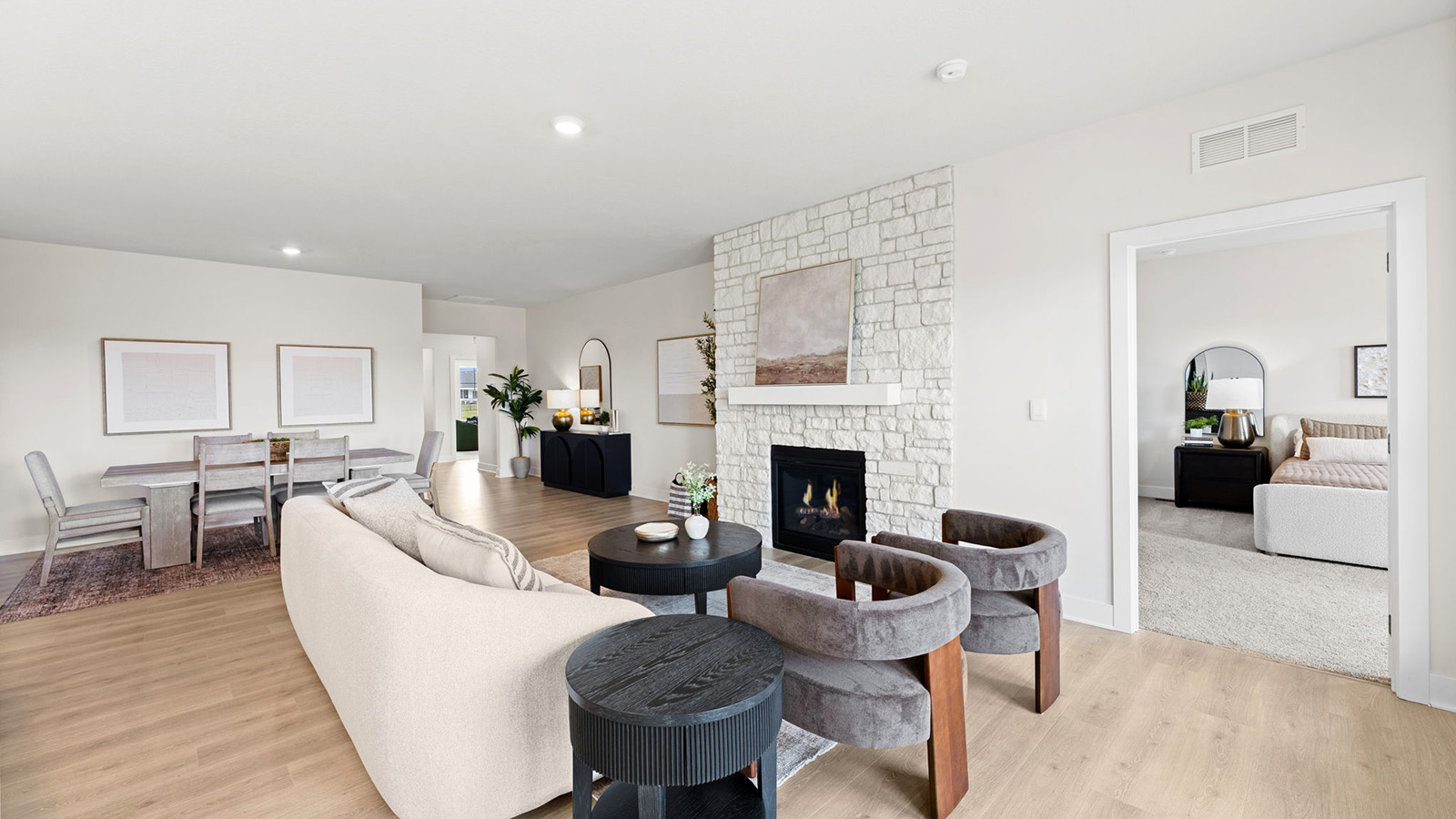 Living room beside kitchen, with electric fireplace and large window