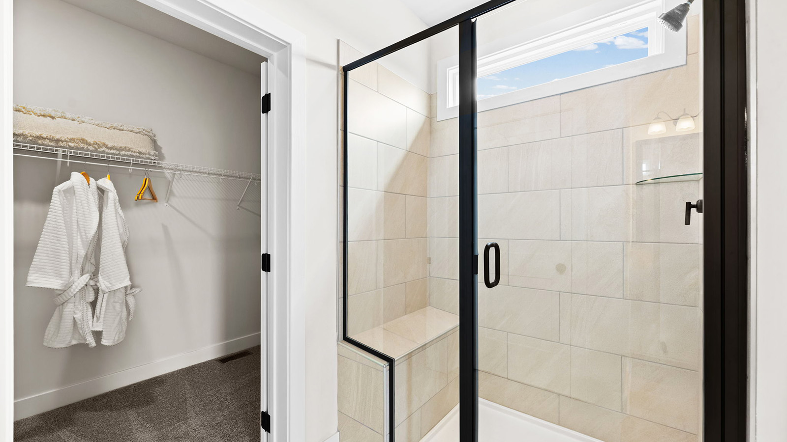 Primary bathroom with double vanity and shower with glass door