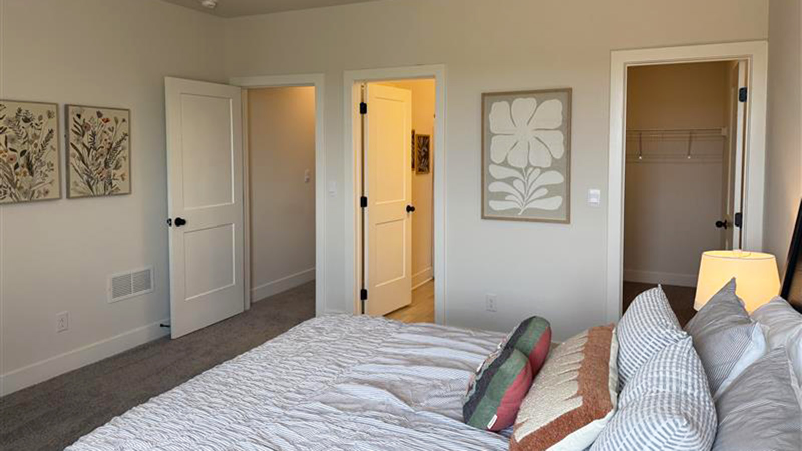 Carpeted basement bedroom with large windows and closet
